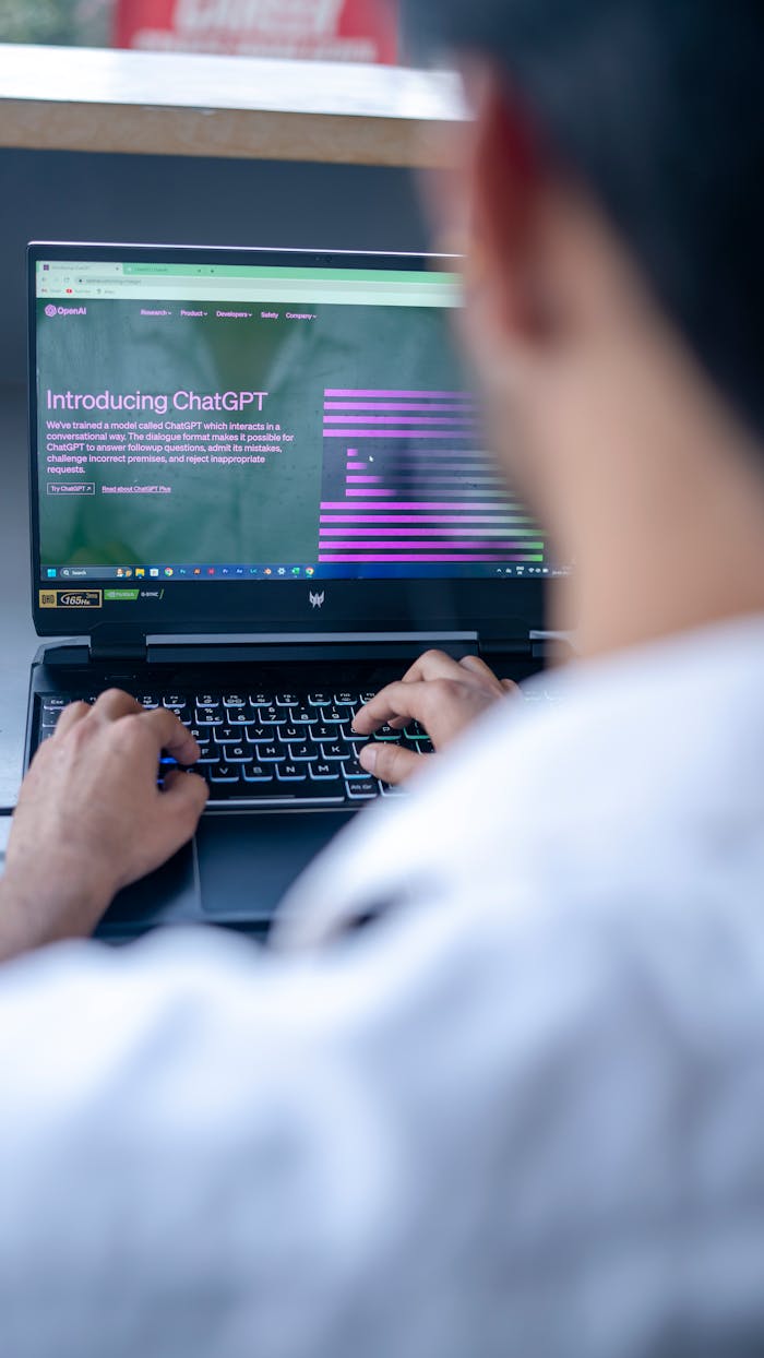 Focused shot of a man using ChatGPT on laptop. Ideal for tech-related content.